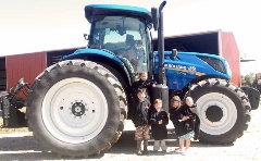 Cole, Kaitlyn, Blake, Wade and Gwendolyn Ferris sporting their Williams Farm gear in front of a New Holland tractor.